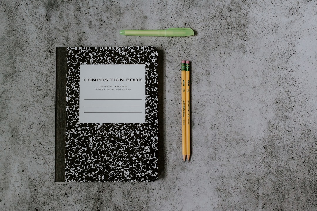 person writing goals notebook